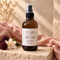 ELARI Her Muse 4 oz moisturizing body elixir in an amber pump bottle